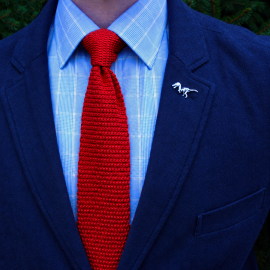 Cravatta rossa a maglia uomo tricot indossata con abito blu