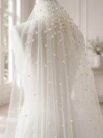 Dettaglio della decorazione sfumata di perle sul tulle del velo GW-VL012