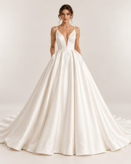 Abito da sposa principesco minimal chic avorio con scollo a V profondo, corpetto sagomato, tasche laterali e ampia gonna con pieghe.